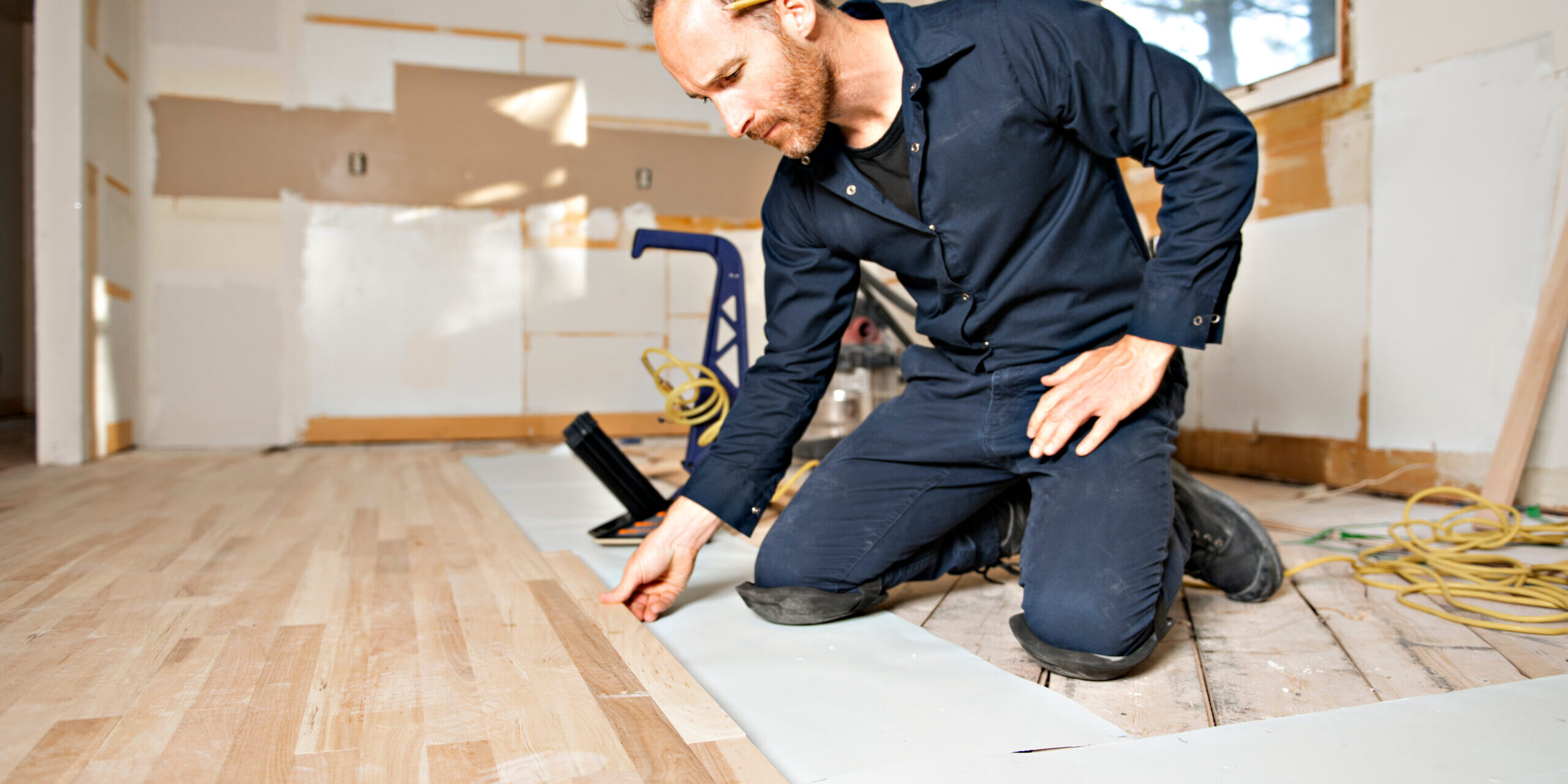 A Male Worker install wood floor on a house Flipping tips for flippers and managers in Burlingame, CA